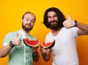 two men eating fruit